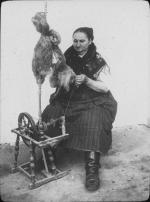 A woman in Austria spins at a wheel, undated