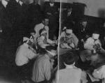 Men eating while blindfolded, c. 1911-1914