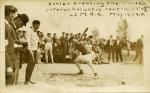 Kohler breaking the world's interscholastic shot put record at M.A.C., 1910
