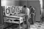 Men playing pinball at the Union, 1971