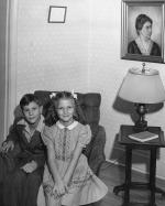 Frank and Margaret Thorp as children sitting on a chair, ca. 1940s