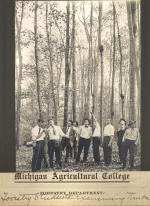 Forestry students examining timber, date unknown