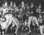 Players lift Coach Munn after the Rose Bowl, 1954