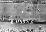 A football game takes place behind a foot race, 1934