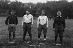 Four football coaches pose on the field, date unknown