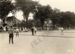 Men playing a tennis game along E. Grand River, 1920 ca.