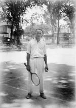A tennis player poses, date unknown