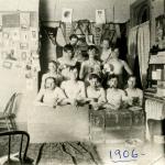 Shirtless male students in a dorm room, 1906