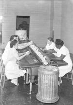Kitchen staff preparing food, 1955