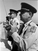 Two Michigan State University Officers Using Binoculars