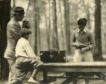Onn Mann Liang preparing surveying equipment, circa 1924