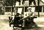 Onn Mann Liang seated outside a house with unidentified man, circa 1925