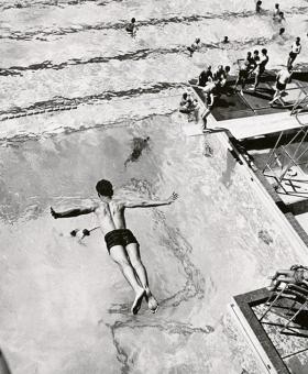 Male student diving into pool 1965 title=Male student diving into pool 1965