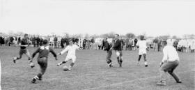 Players in action during a soccer match, 1959 title=Players in action during a soccer match, 1959
