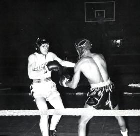 Two men boxing in the ring, 1957 title=Two men boxing in the ring, 1957