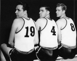 Three basketball players look over their shoulders, 1948